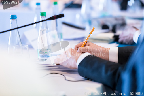 Image of close up of business people taking notes