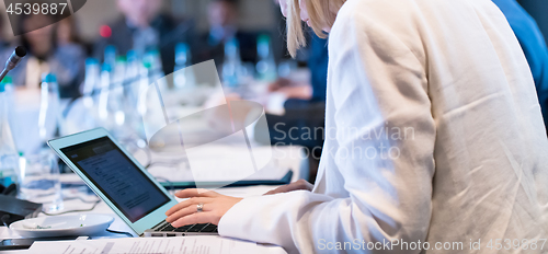 Image of close up of business people hands using laptop computer