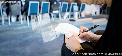 Image of close up of business people taking notes