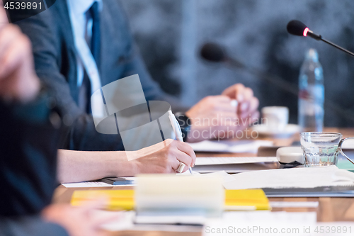 Image of close up of business people taking notes