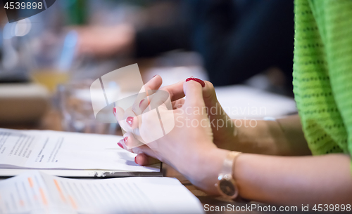 Image of close up of business people taking notes