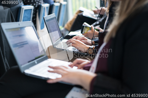 Image of close up of business people hands using laptop computer