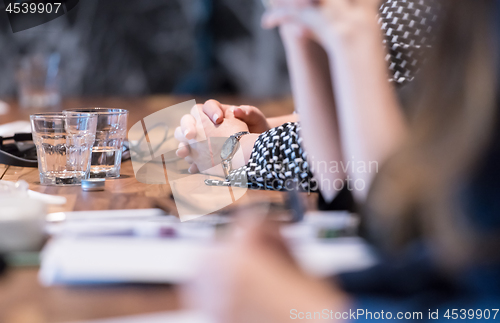 Image of close up of business people taking notes