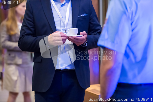 Image of closeup of businessman holding a cup of coffee