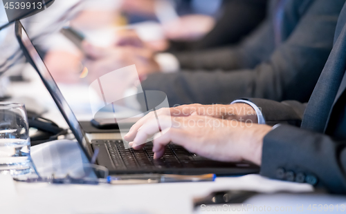 Image of close up of business people hands using laptop computer