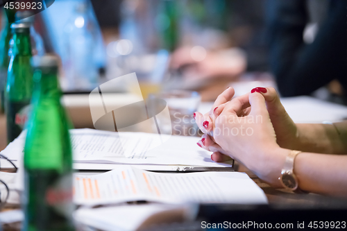 Image of close up of business people taking notes