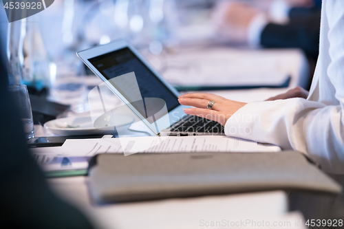 Image of close up of business people hands using laptop computer