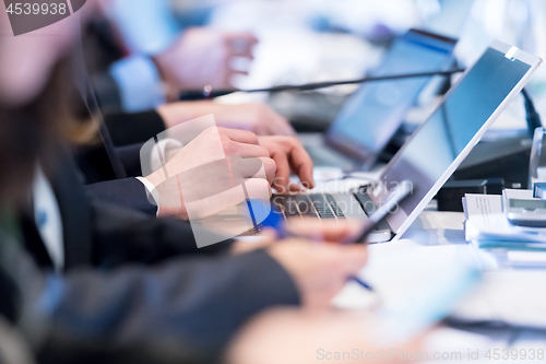 Image of close up of business people hands using laptop computer