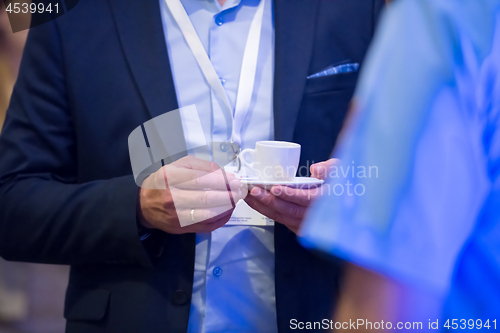 Image of closeup of businessman holding a cup of coffee