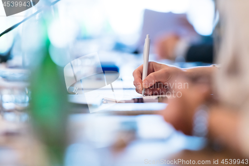 Image of close up of business people taking notes