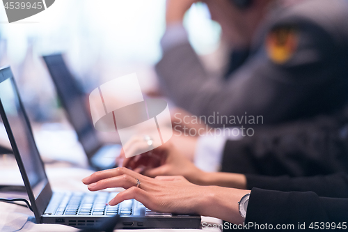 Image of close up of business people hands using laptop computer