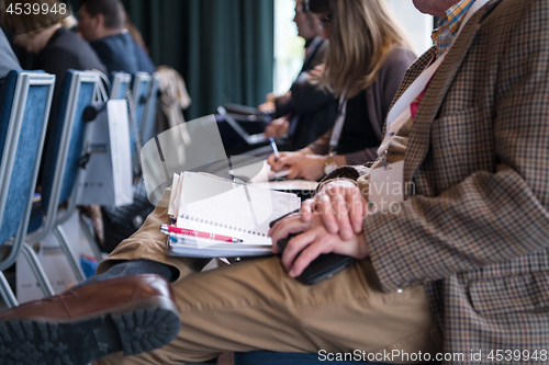 Image of close up of business people taking notes