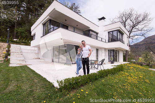 Image of couple hugging in front of  new luxury home