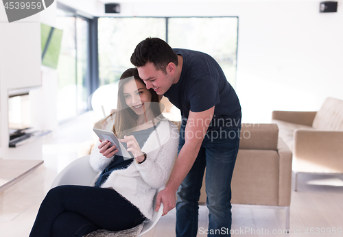 Image of couple using tablet at home