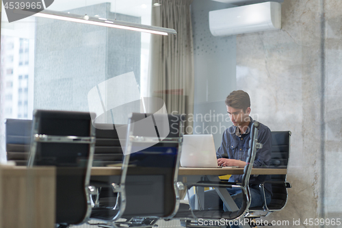 Image of businessman working using a laptop in startup office