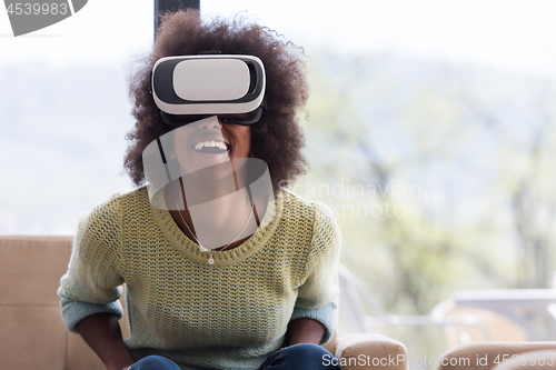Image of black woman using VR headset glasses of virtual reality