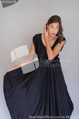Image of woman in a black dress isolated on white background