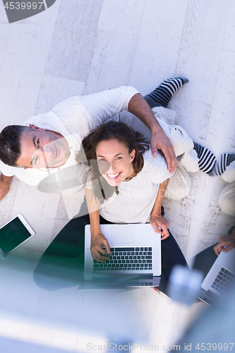 Image of couple using tablet and laptop computers top view