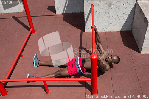 Image of Athlete doing exercises at stadium