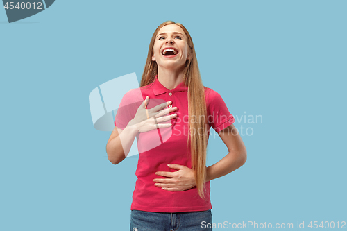Image of The happy business woman standing and smiling against blue background.