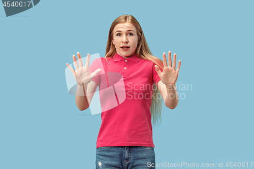 Image of Portrait of the scared woman on blue