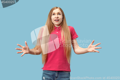 Image of Beautiful woman looking suprised isolated on blue