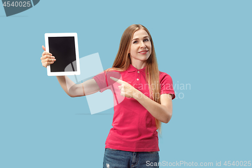 Image of Portrait of a confident casual girl showing blank screen of laptop isolated over blue background