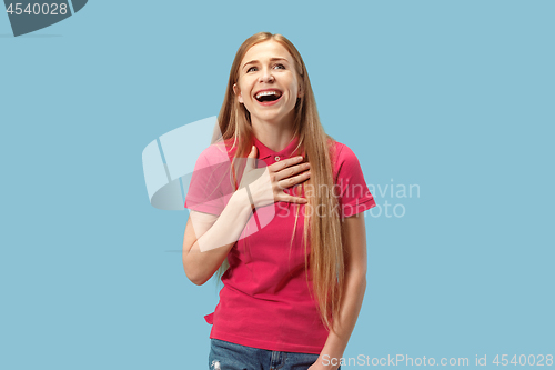 Image of The happy business woman standing and smiling against blue background.