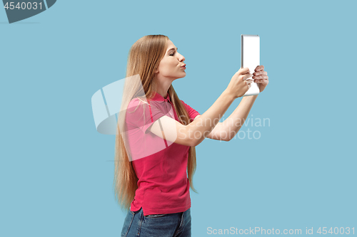 Image of The happy businesswoman with red laptop on blue