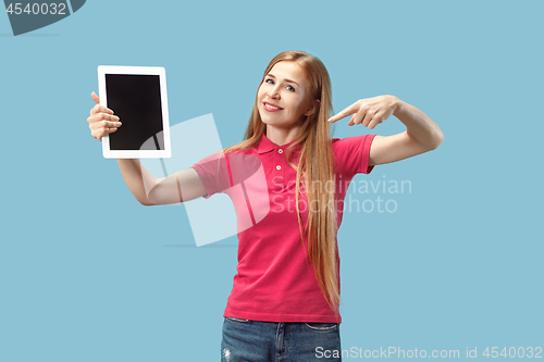 Image of Portrait of a confident casual girl showing blank screen of laptop isolated over blue background