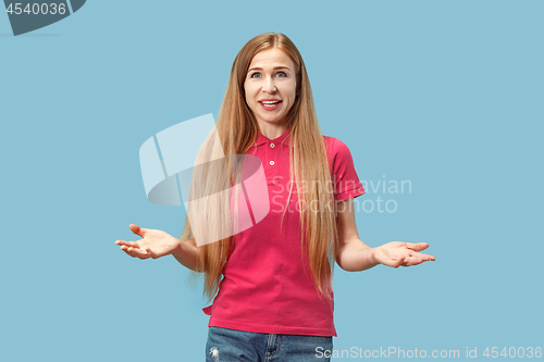 Image of The happy business woman standing and smiling against blue background.
