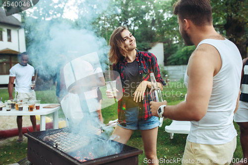 Image of Group of friends making barbecue in the backyard. concept about good and positive mood with friends