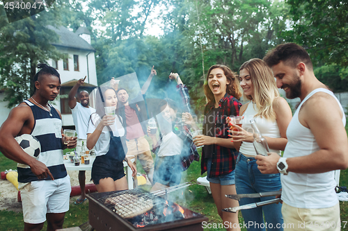 Image of Group of friends making barbecue in the backyard. concept about good and positive mood with friends