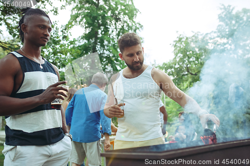 Image of Group of friends making barbecue in the backyard. concept about good and positive mood with friends