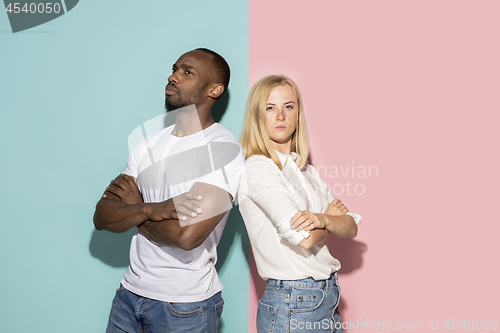 Image of Young serious thoughtful afro man and woman at studio