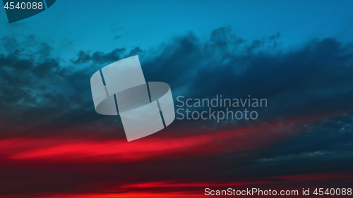 Image of Colorful Red Glow On A Dark Cloudy Dramatic Sky