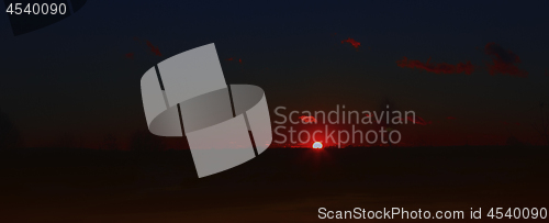 Image of Dark Night Landscape With Glowing Red Sunset