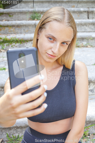 Image of Attractive young woman taking selfie.