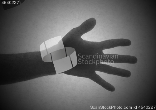 Image of Silhouette behind a transparent paper