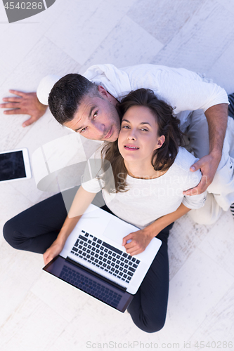 Image of couple using tablet and laptop computers top view