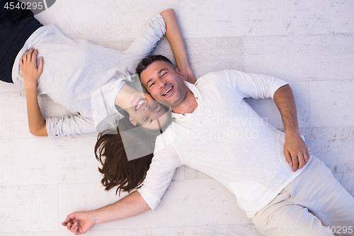 Image of handsome couple lying on floor