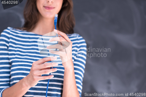 Image of woman holding a internet cable in front of chalk drawing board