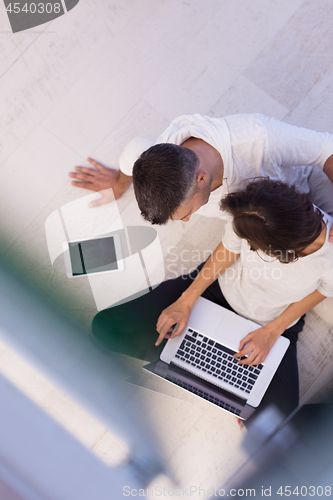 Image of couple using tablet and laptop computers top view