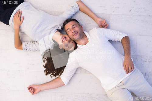 Image of handsome couple lying on floor