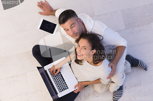 Image of couple using tablet and laptop computers top view