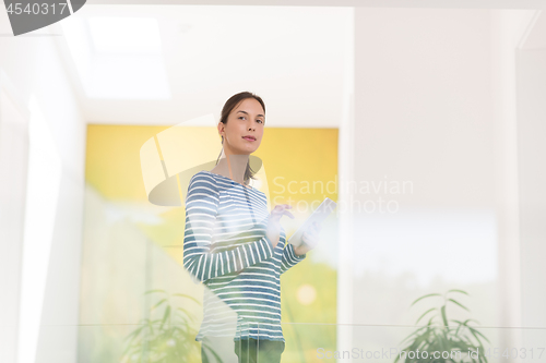 Image of young woman at home websurfing