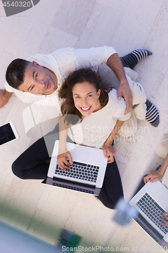 Image of couple using tablet and laptop computers top view