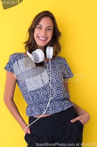 Image of woman with headphones isolated on a yellow