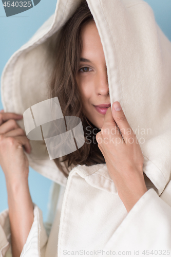 Image of woman in a white coat with hood isolated on blue background