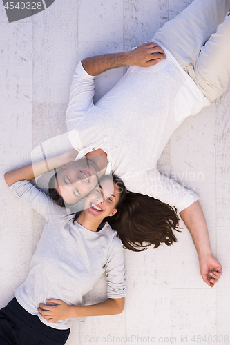 Image of handsome couple lying on floor